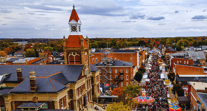 Aerial view of the Circleville Pumpkin Show filling Main Street beside the courthouse in autumn