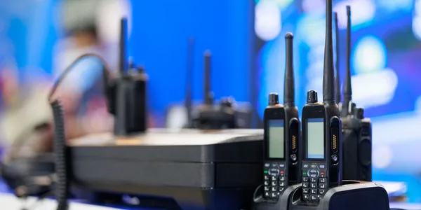Portable two-way radios in a charging bank at a public safety dispatch console